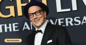 Rob Schneider Biography 2026 featuring the American comedian and actor Image shows Rob Schneider during a stand-up comedy performance Highlights his career, age, height, and family background