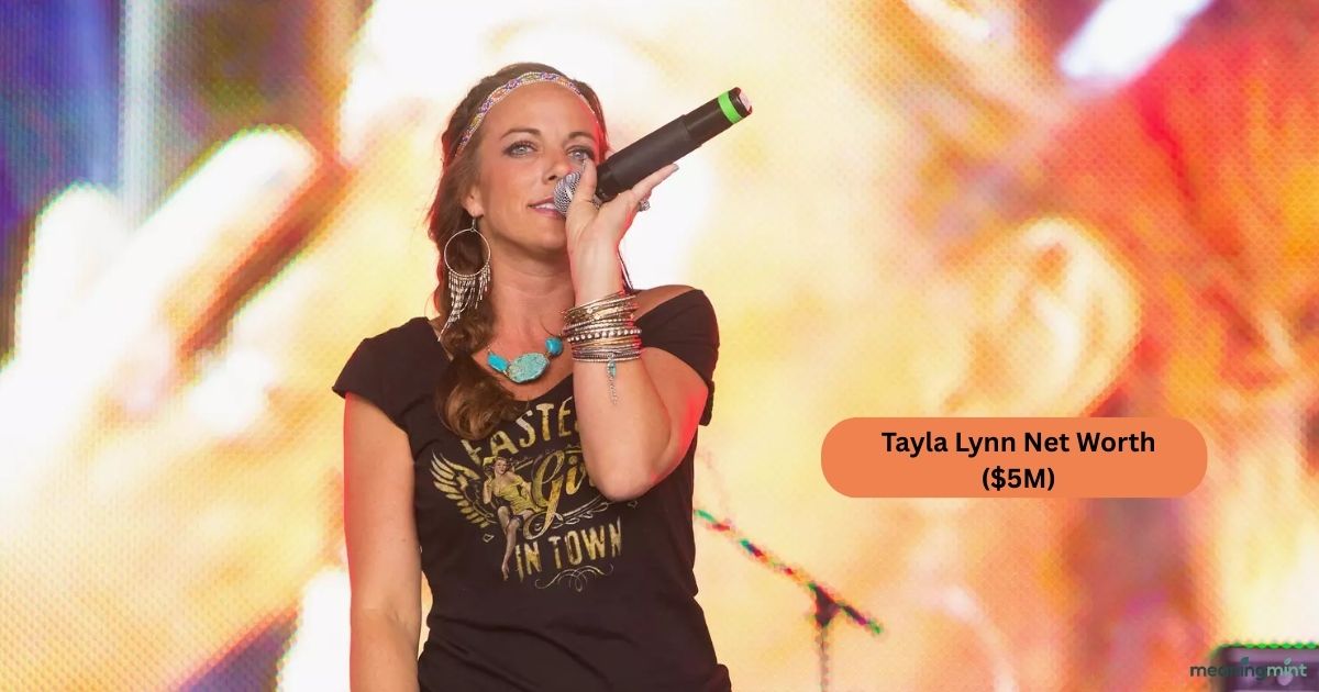 Tayla Lynn performing on stage with her guitar. Fans celebrate her country music success and achievements. Tayla Lynn Net Worth reflects her musical career and legacy.